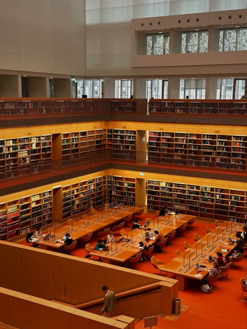 pexels-photo-17373688-17373688 Vibrant interior of a multi-level library in Berlin with people studying.